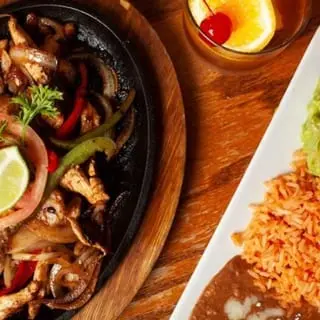 Chicken Sizzling Fajita with peppers and onions in a skillet